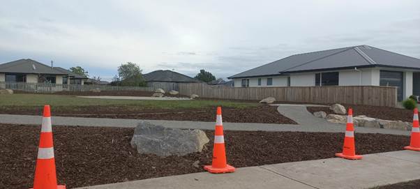 A road cone in front of a house

Description automatically generated