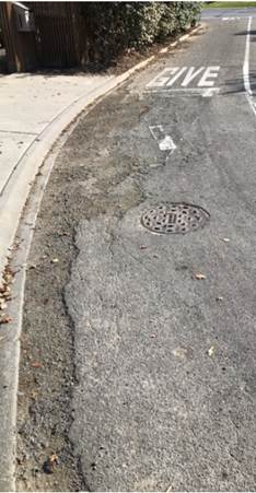A street with a drain

Description automatically generated