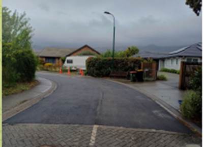 A road with orange cones on the side

Description automatically generated
