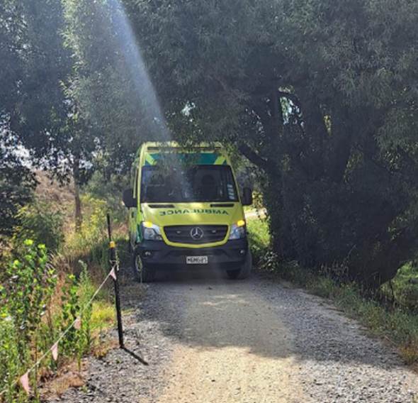 A yellow van on a gravel road

Description automatically generated