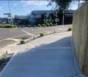 A sidewalk with a corner of a building

Description automatically generated with medium confidence