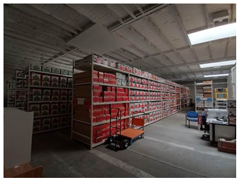 A warehouse with shelves of goods

Description automatically generated