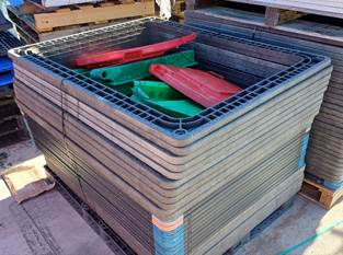 A stack of pallets with plastic crates

Description automatically generated