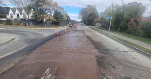 A road with a puddle of water

Description automatically generated