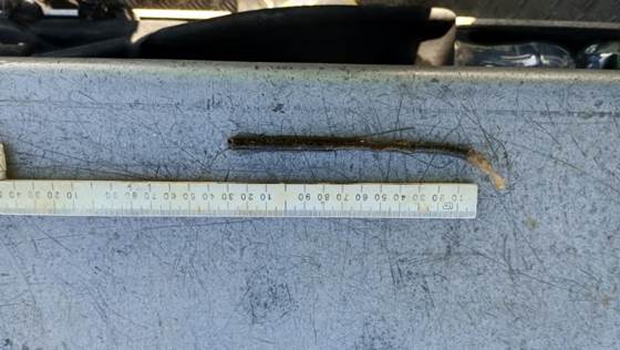 A white ruler on a metal surface

Description automatically generated