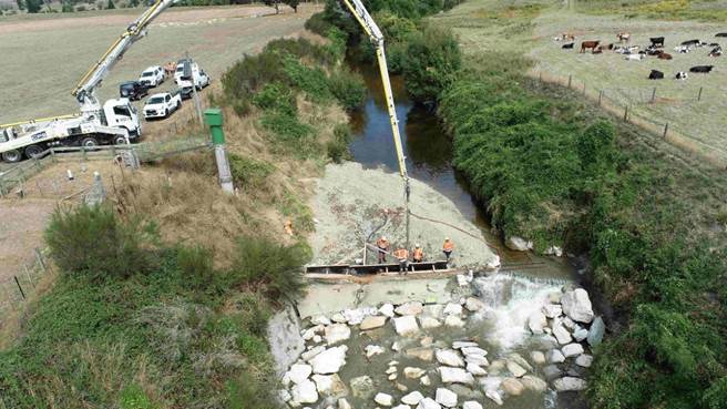 A crane lifting a pile of rocks

Description automatically generated with medium confidence