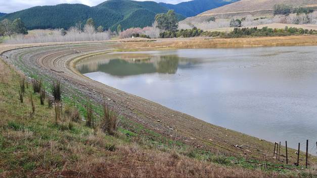 A reflection of a lake in a field

Description automatically generated
