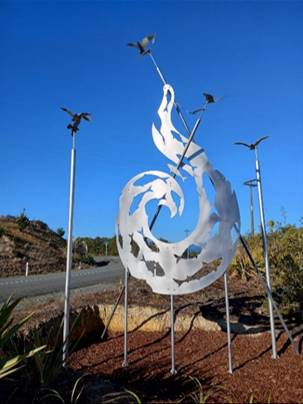 A metal sculpture of a wind turbine

Description automatically generated