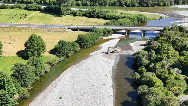 A river with a bridge and trees

AI-generated content may be incorrect.