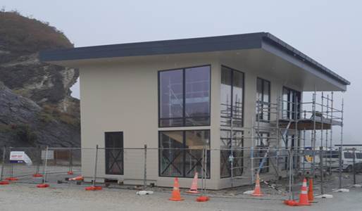 A building under construction with orange cones

AI-generated content may be incorrect.