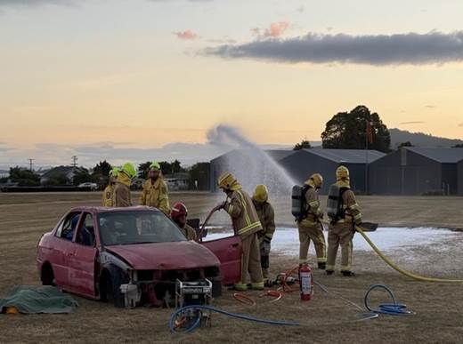 A group of firefighters working on a car

AI-generated content may be incorrect.
