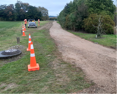 A road with orange cones and a truck on it

AI-generated content may be incorrect.