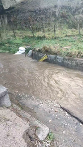 A water flowing through a ditch

AI-generated content may be incorrect.