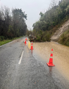 A road with orange cones on it

AI-generated content may be incorrect.